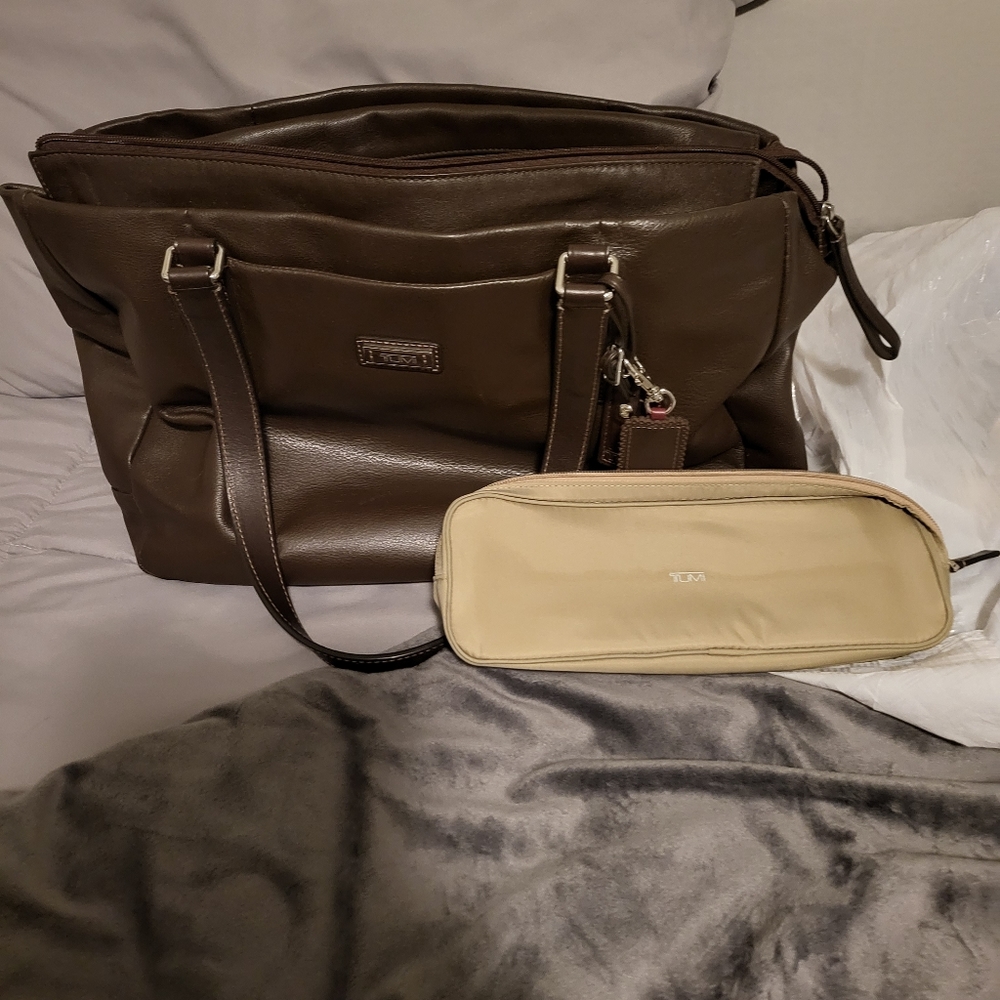 Tumi all leather tote with multiple pockets and luggage sleeve